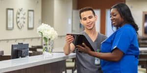 Two nurses looking at a patient chart together.
