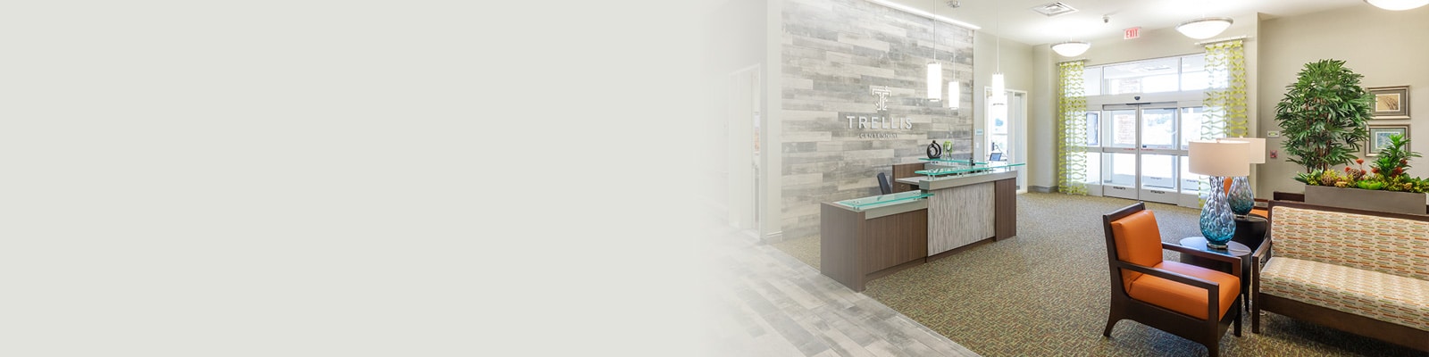 Entrance to the building with a lounge area beside it.